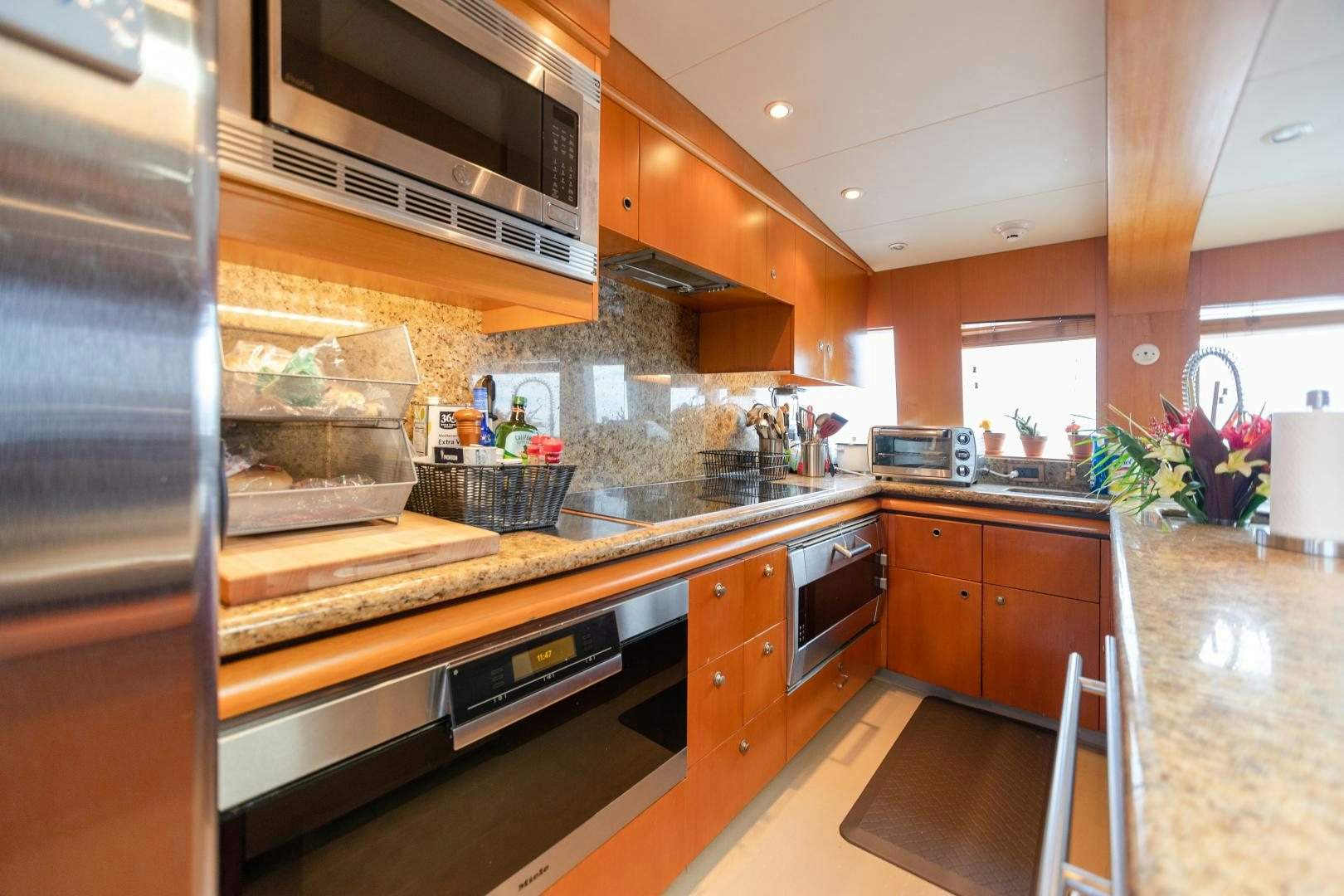 a kitchen with a stainless steel oven aboard XOXO Yacht for Sale