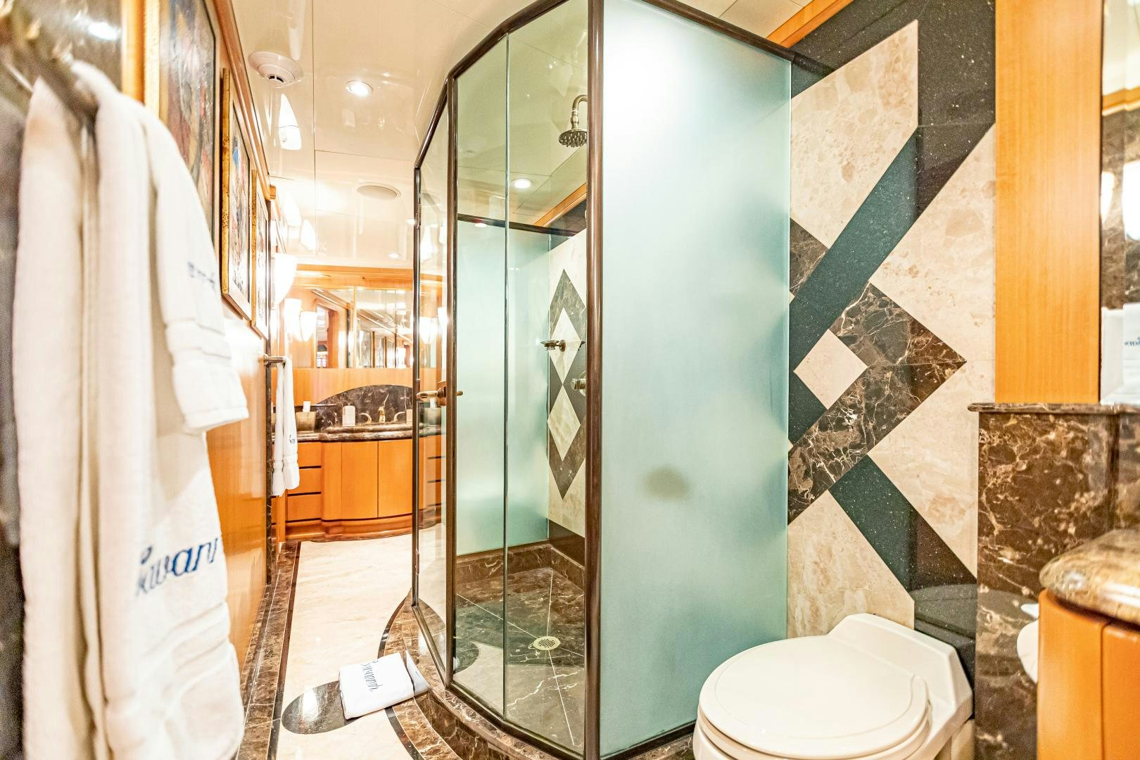 a bathroom with a glass shower aboard XOXO Yacht for Sale