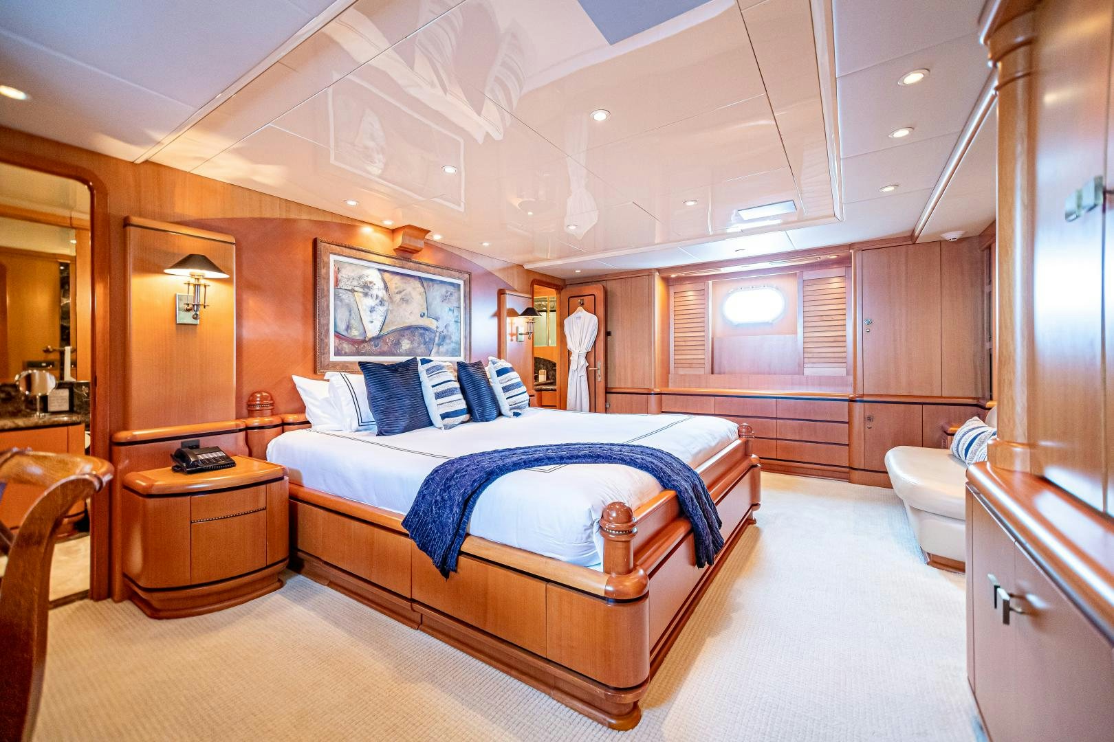 a bedroom with a bed and a desk aboard XOXO Yacht for Sale