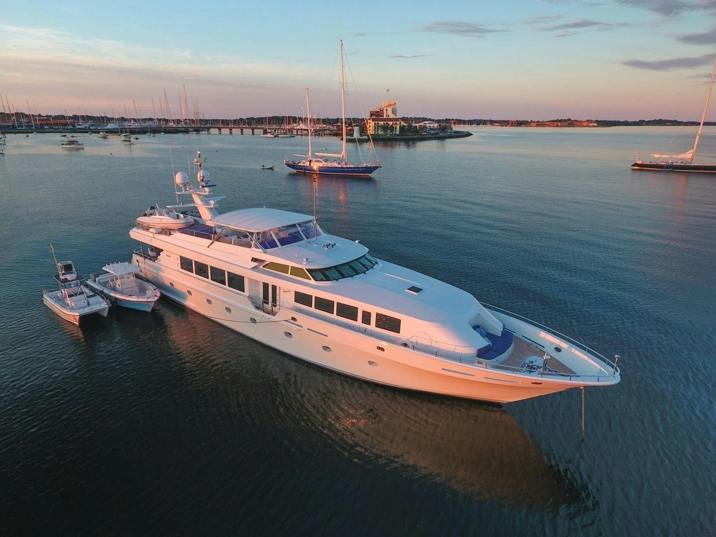 a large white boat sits in the water aboard XOXO Yacht for Sale