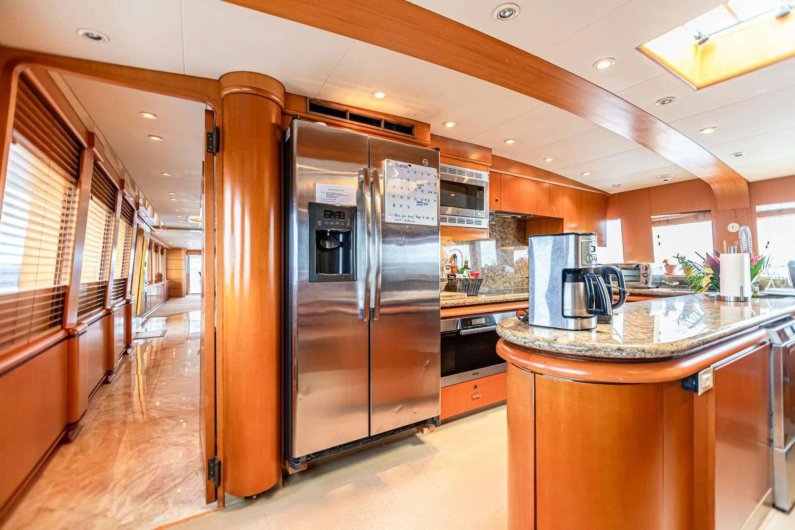 a kitchen with stainless steel appliances aboard XOXO Yacht for Sale
