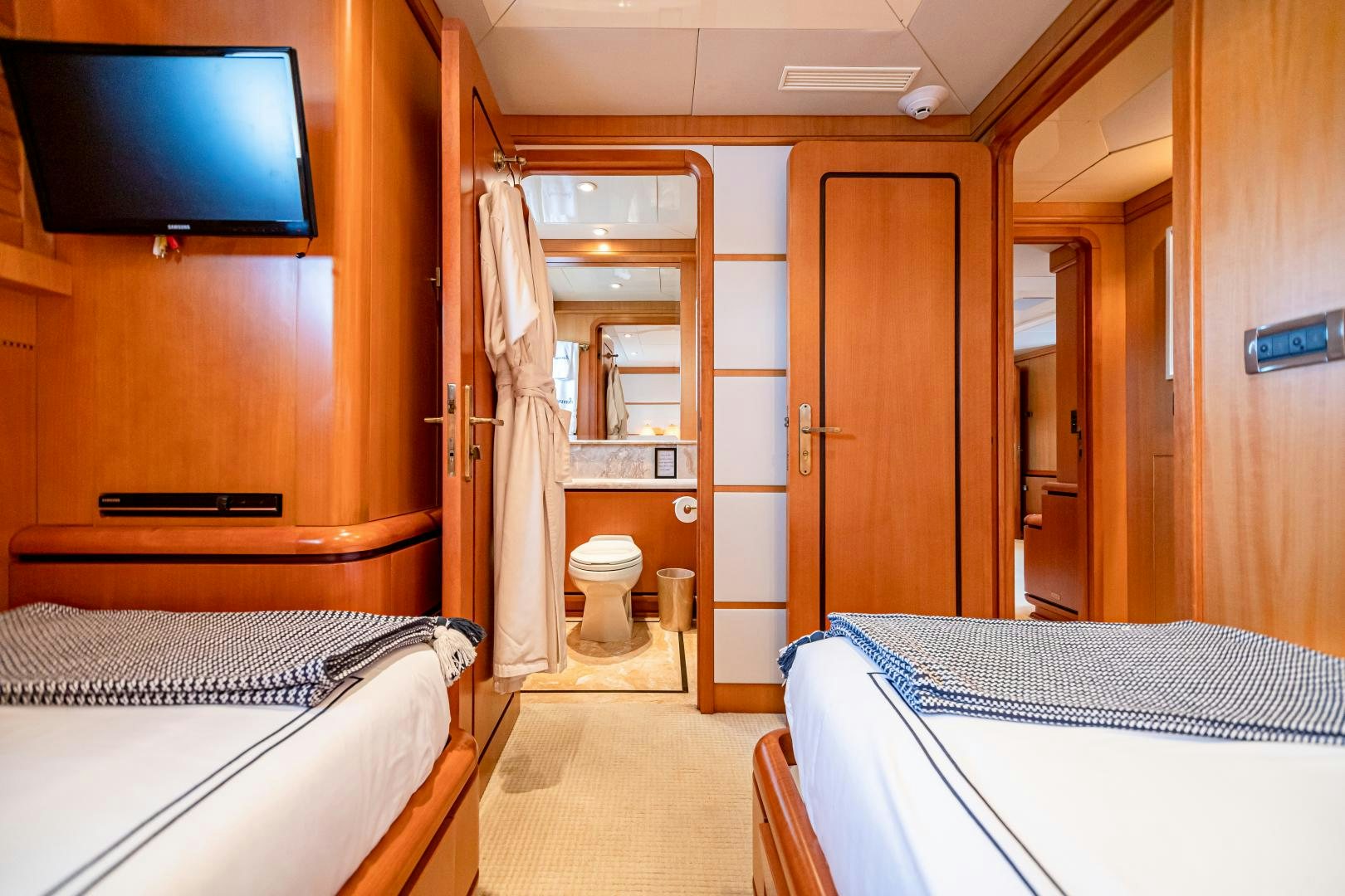 a room with a bed and a television aboard XOXO Yacht for Sale