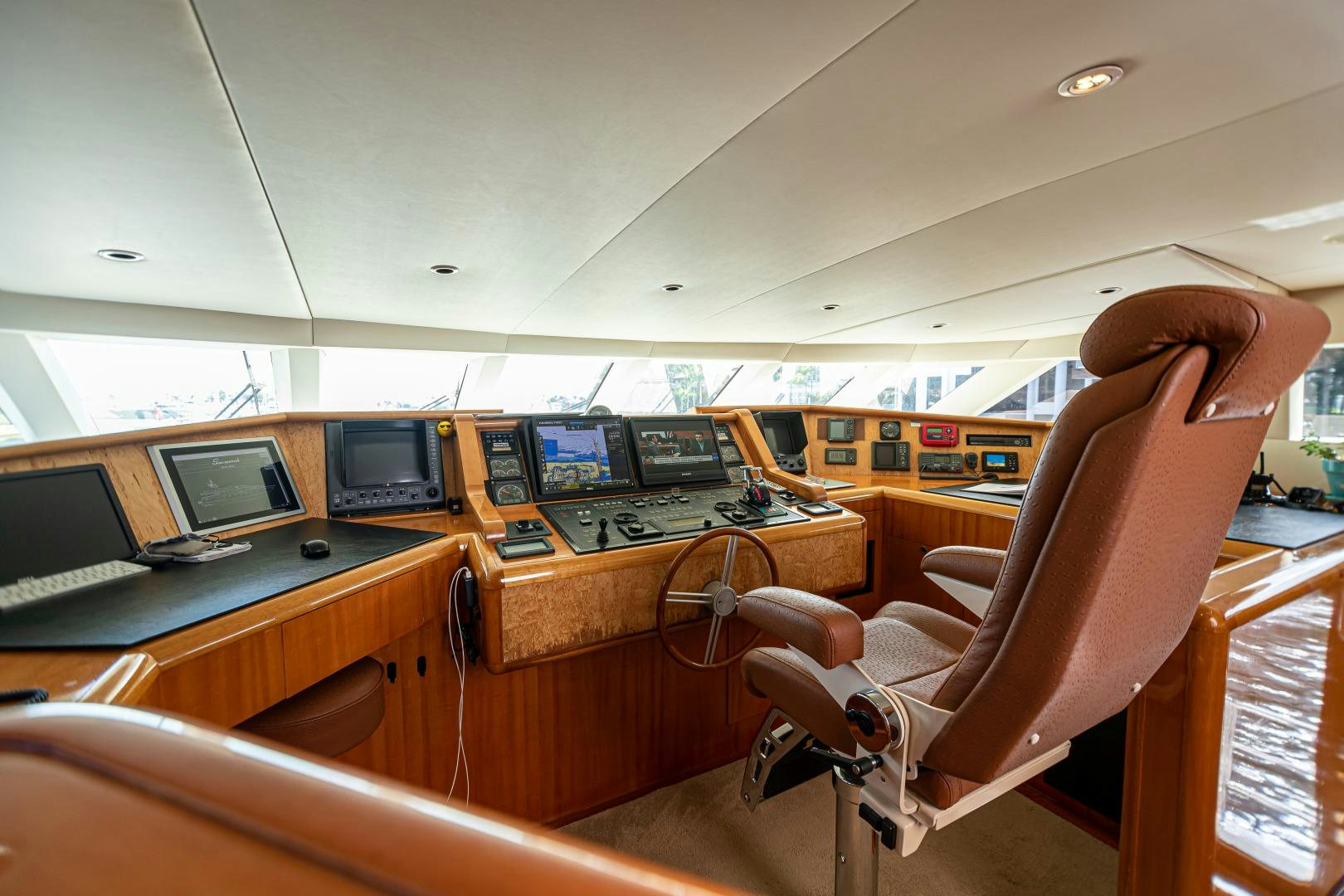 a person sitting at a desk with computers on it aboard XOXO Yacht for Sale