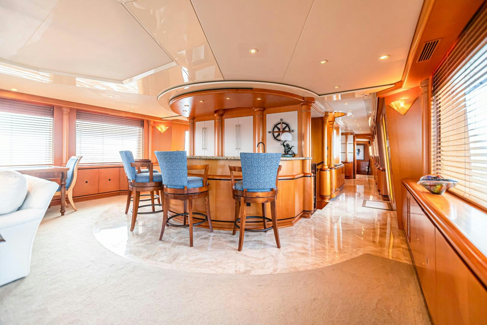 a large room with a table and chairs aboard XOXO Yacht for Sale