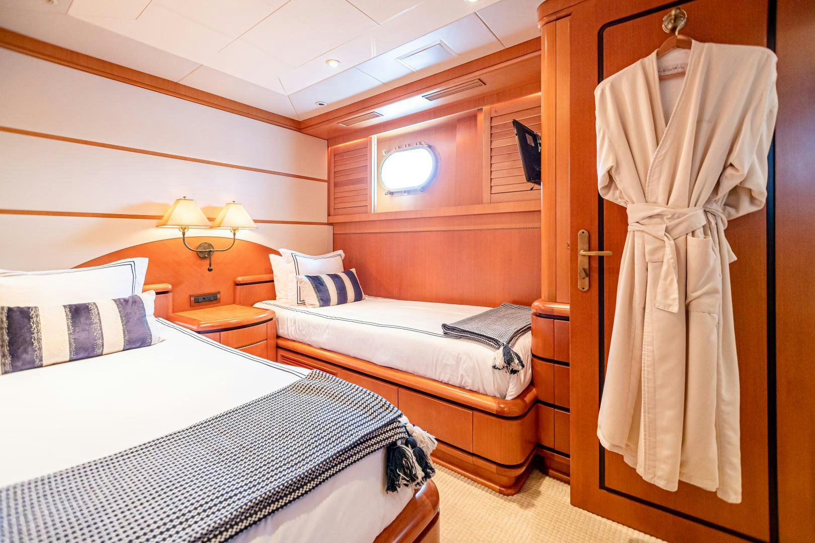a room with beds and a closet aboard XOXO Yacht for Sale