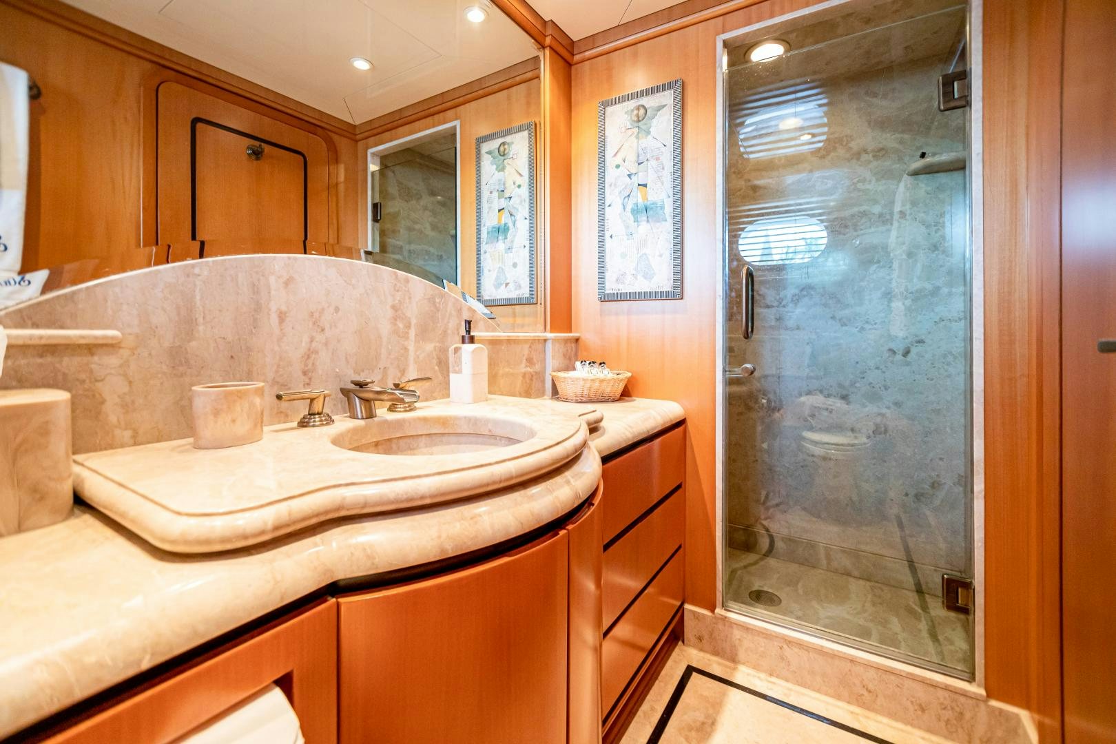 a bathroom with a glass shower aboard XOXO Yacht for Sale