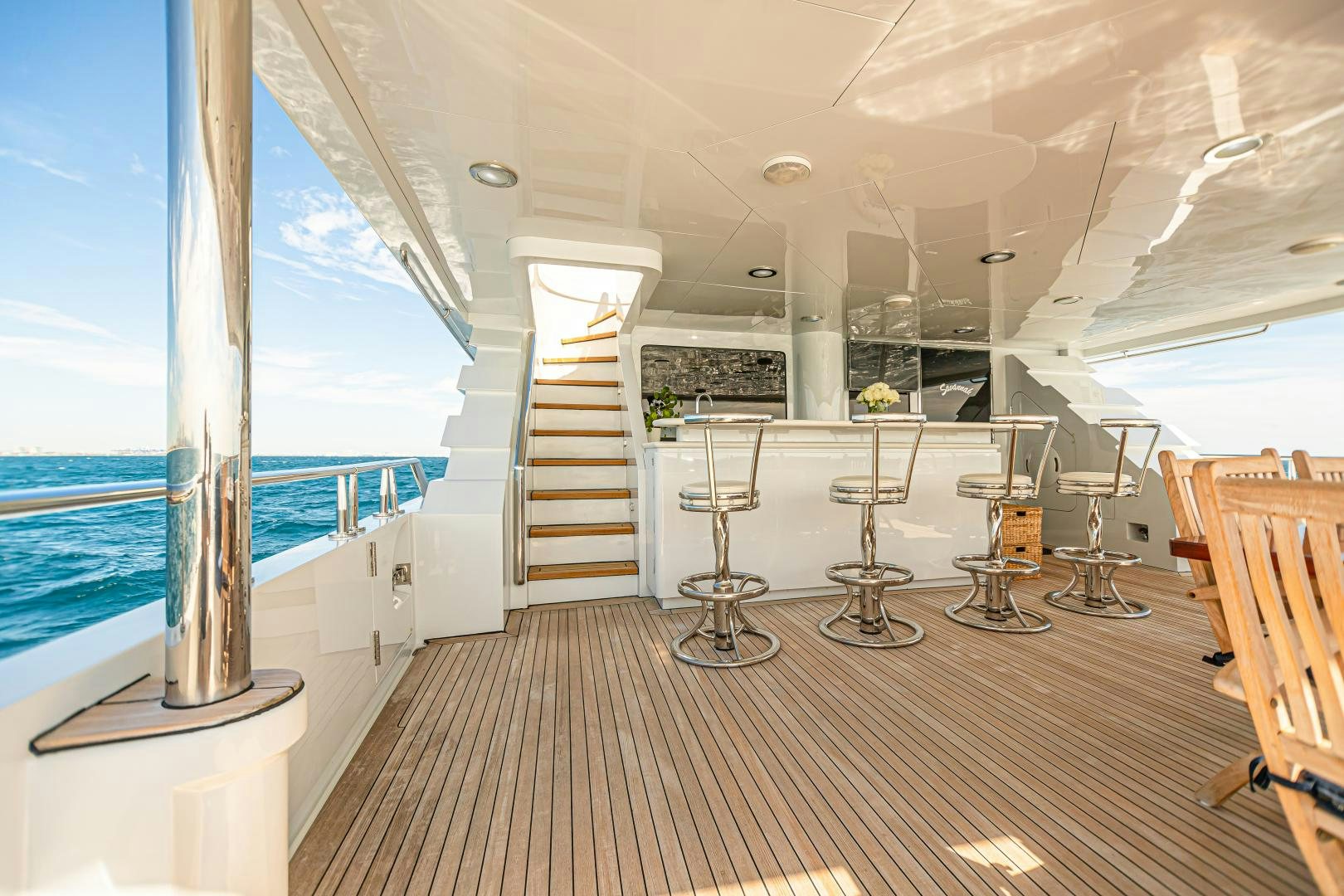 a room with a large window and a wood floor aboard XOXO Yacht for Sale