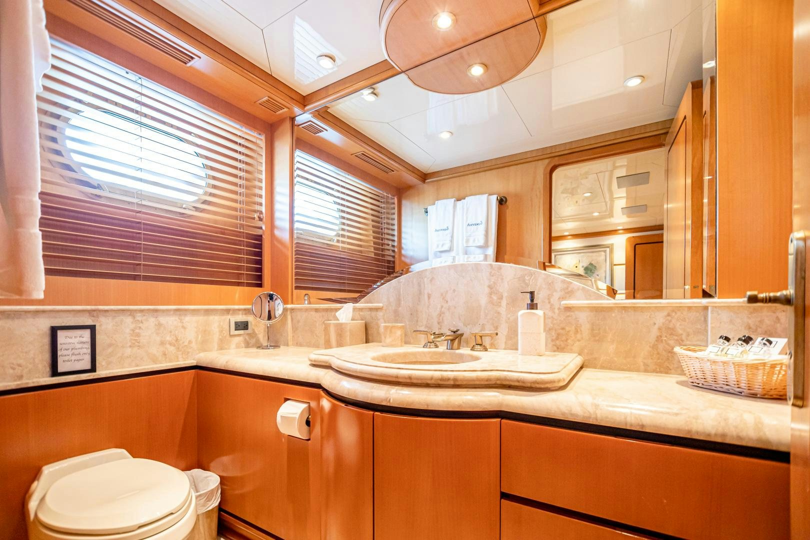 a bathroom with a sink and a toilet aboard XOXO Yacht for Sale