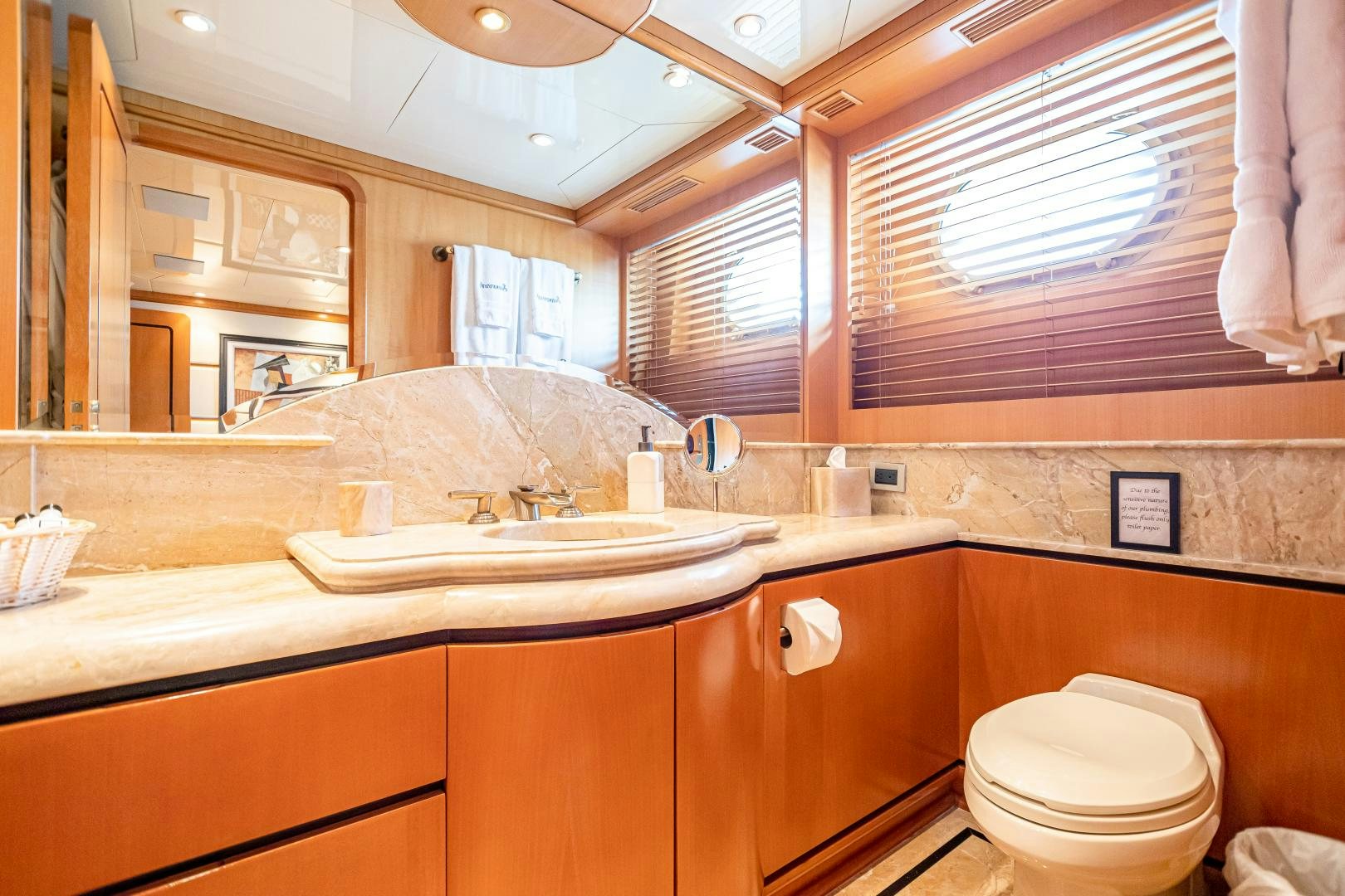 a bathroom with a sink and toilet aboard XOXO Yacht for Sale