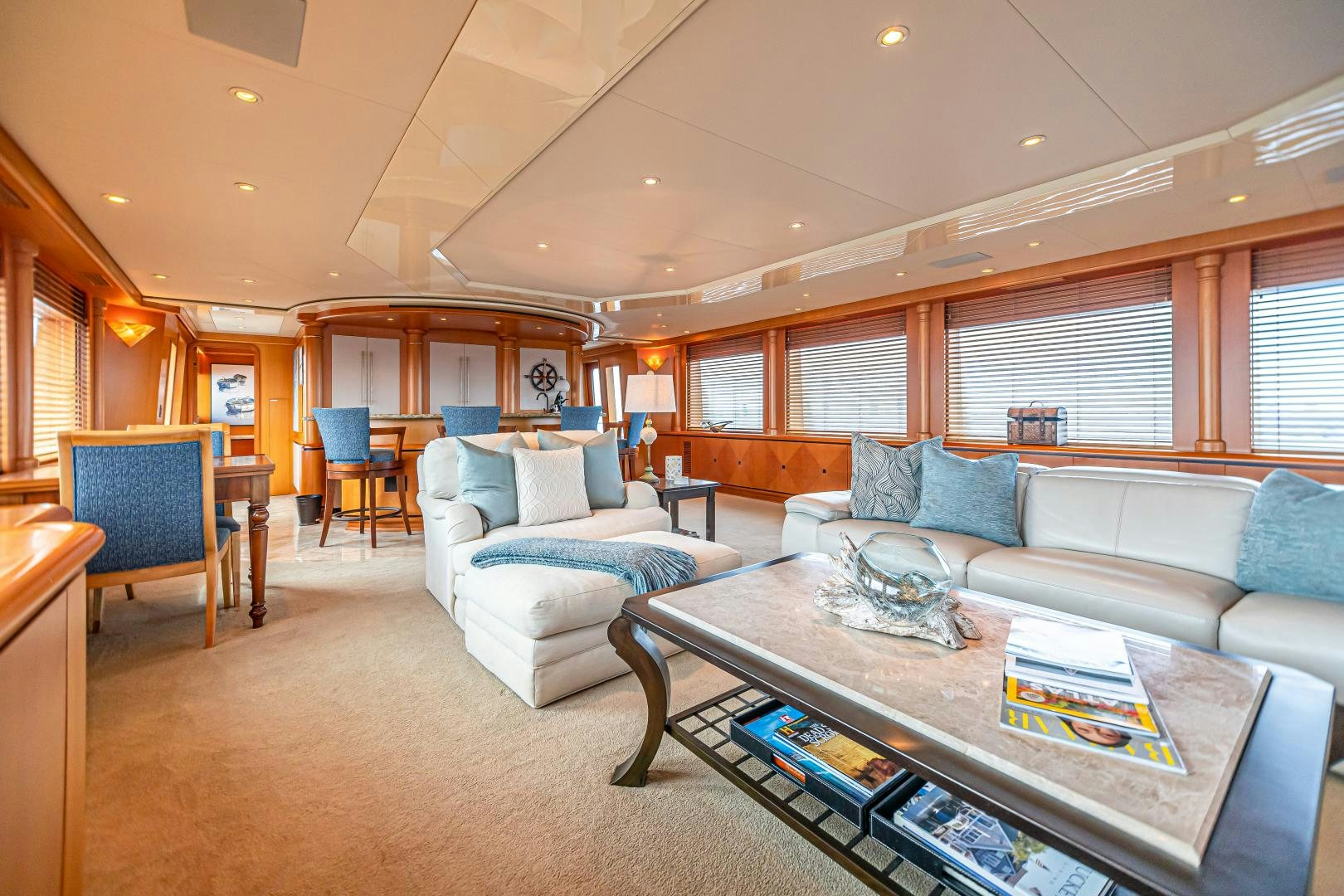 a living room with a couch and a coffee table aboard XOXO Yacht for Sale