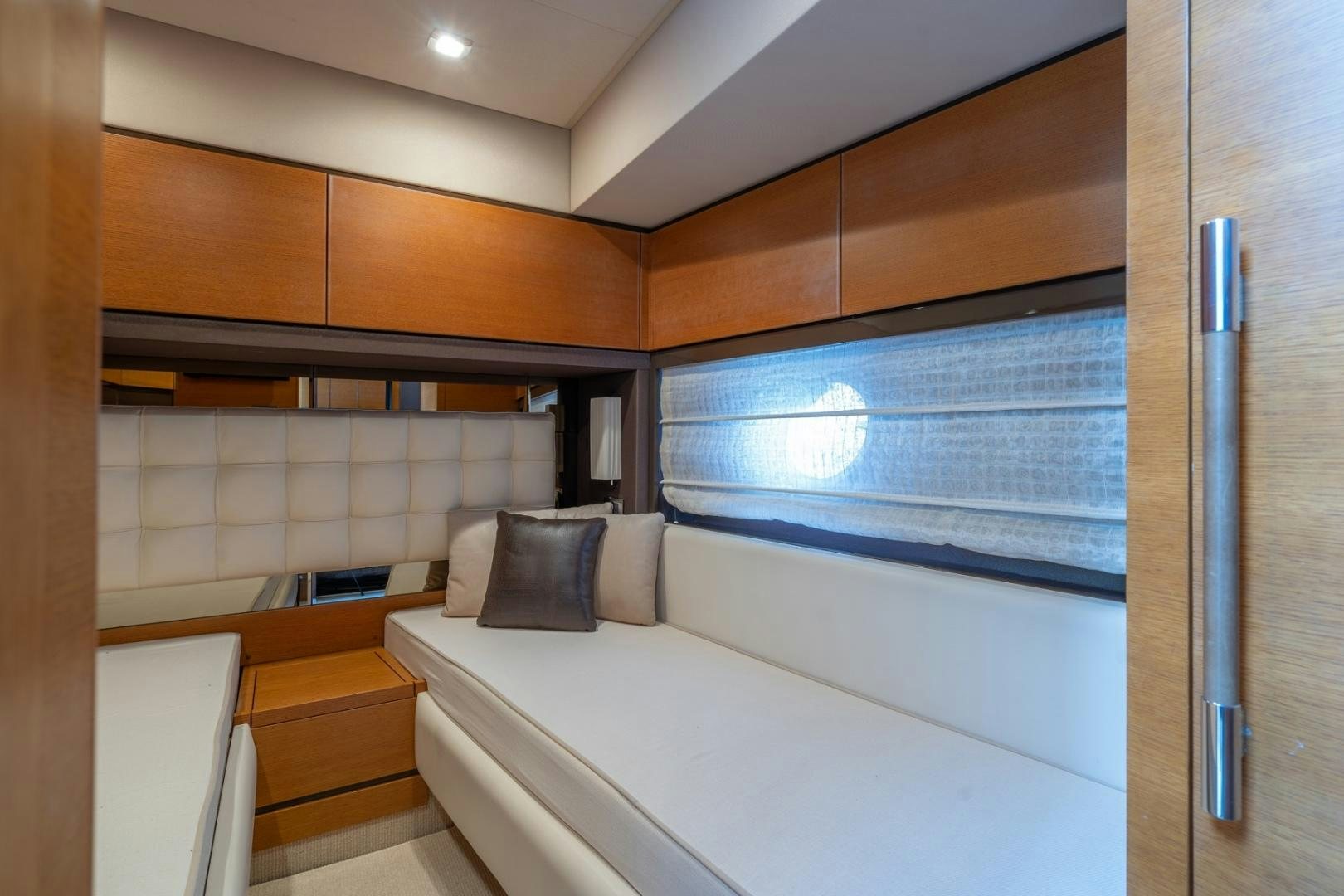 a room with a bed and a window aboard SYLVIA VI Yacht for Sale