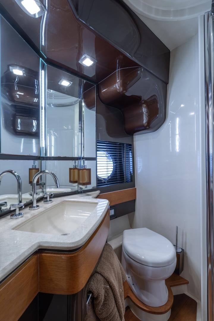 a bathroom with a toilet and sink aboard SYLVIA VI Yacht for Sale