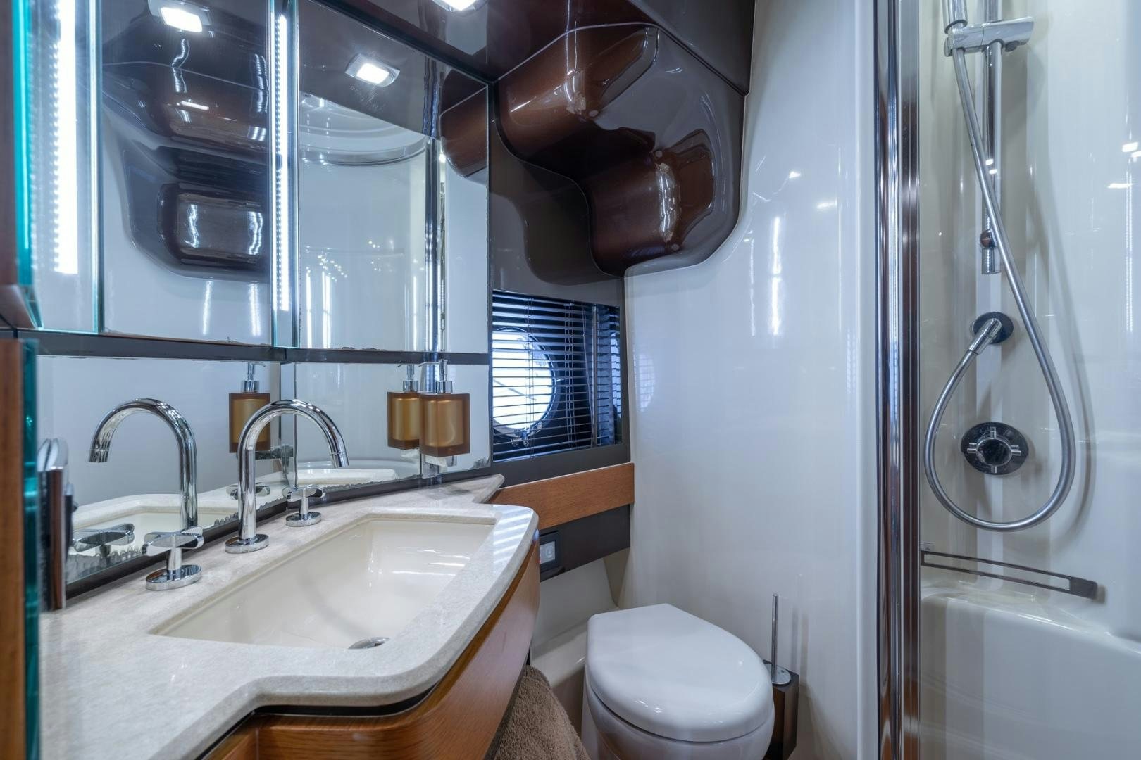 a bathroom with a sink and toilet aboard SYLVIA VI Yacht for Sale