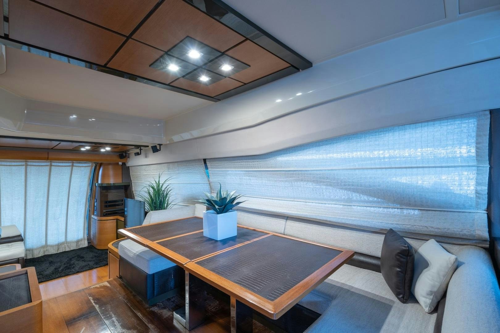 a room with a table and a couch aboard SYLVIA VI Yacht for Sale