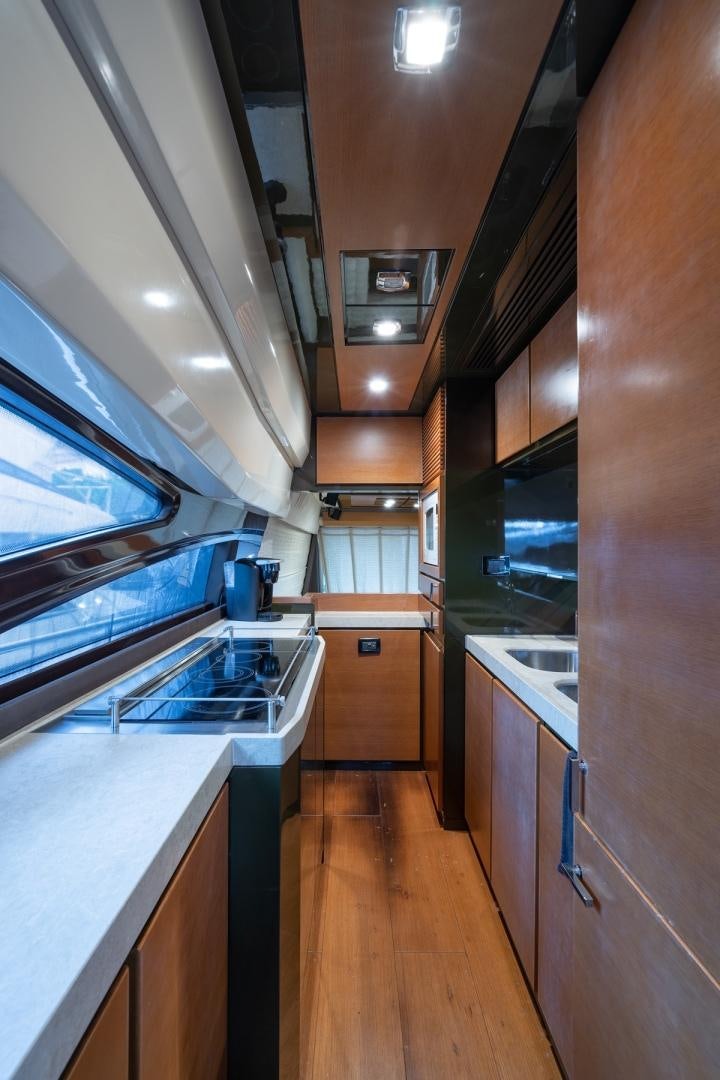 a kitchen with wooden cabinets aboard SYLVIA VI Yacht for Sale