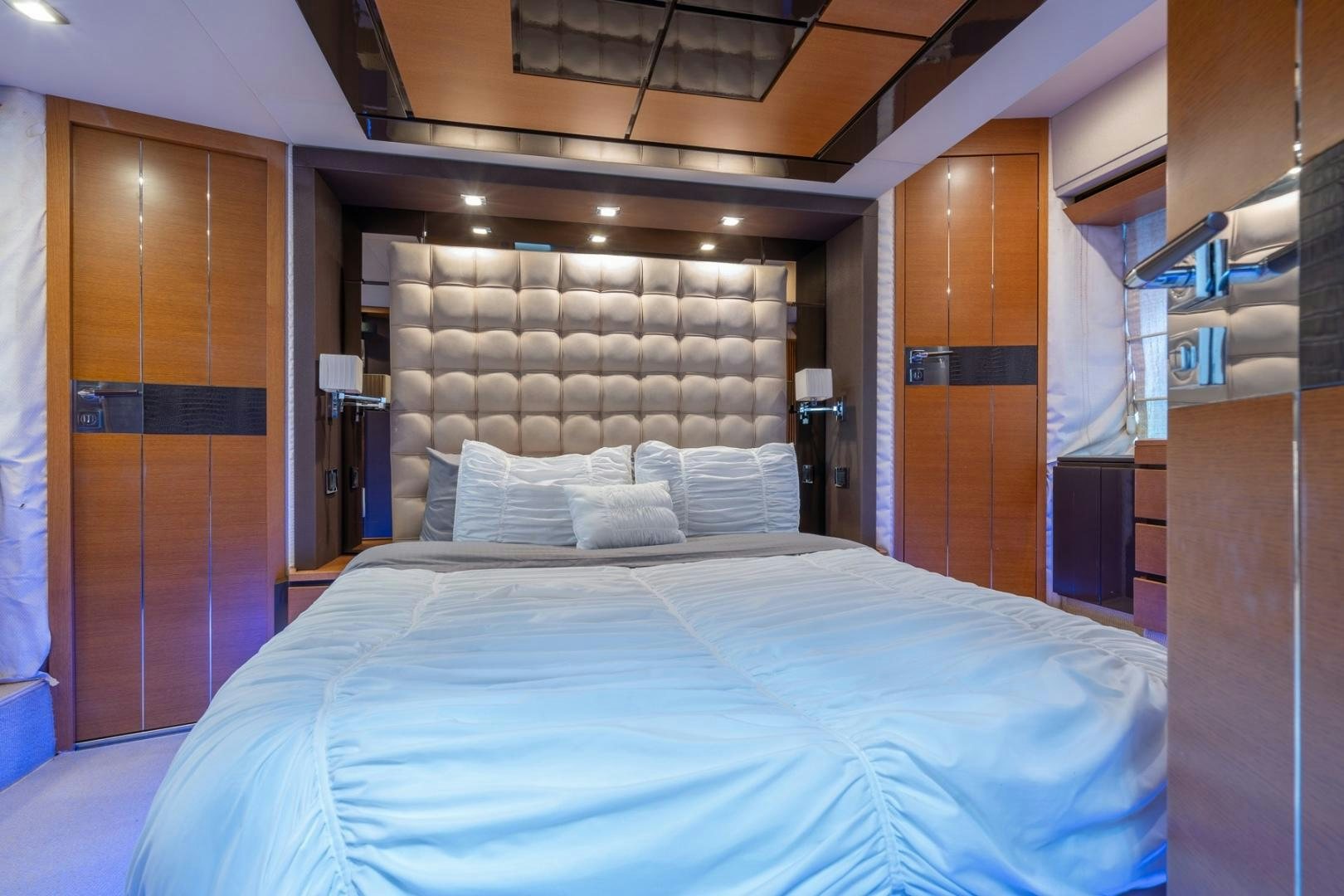 a bed with a blue sheet aboard SYLVIA VI Yacht for Sale