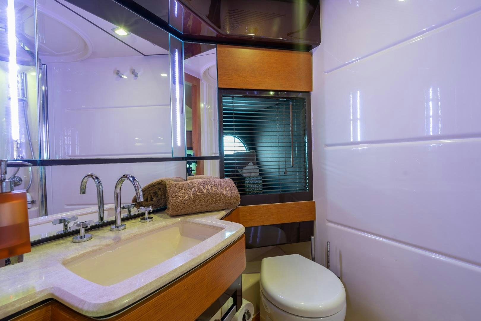 a bathroom with a sink and a toilet aboard SYLVIA VI Yacht for Sale