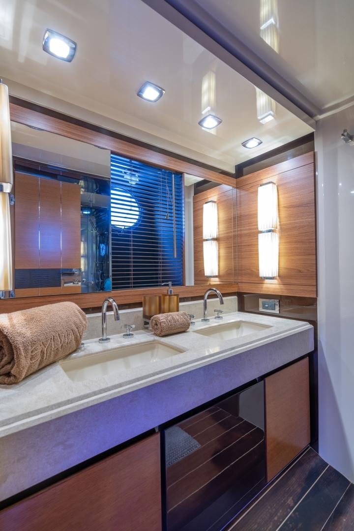 a bathroom with a countertop sink and a mirror aboard SYLVIA VI Yacht for Sale