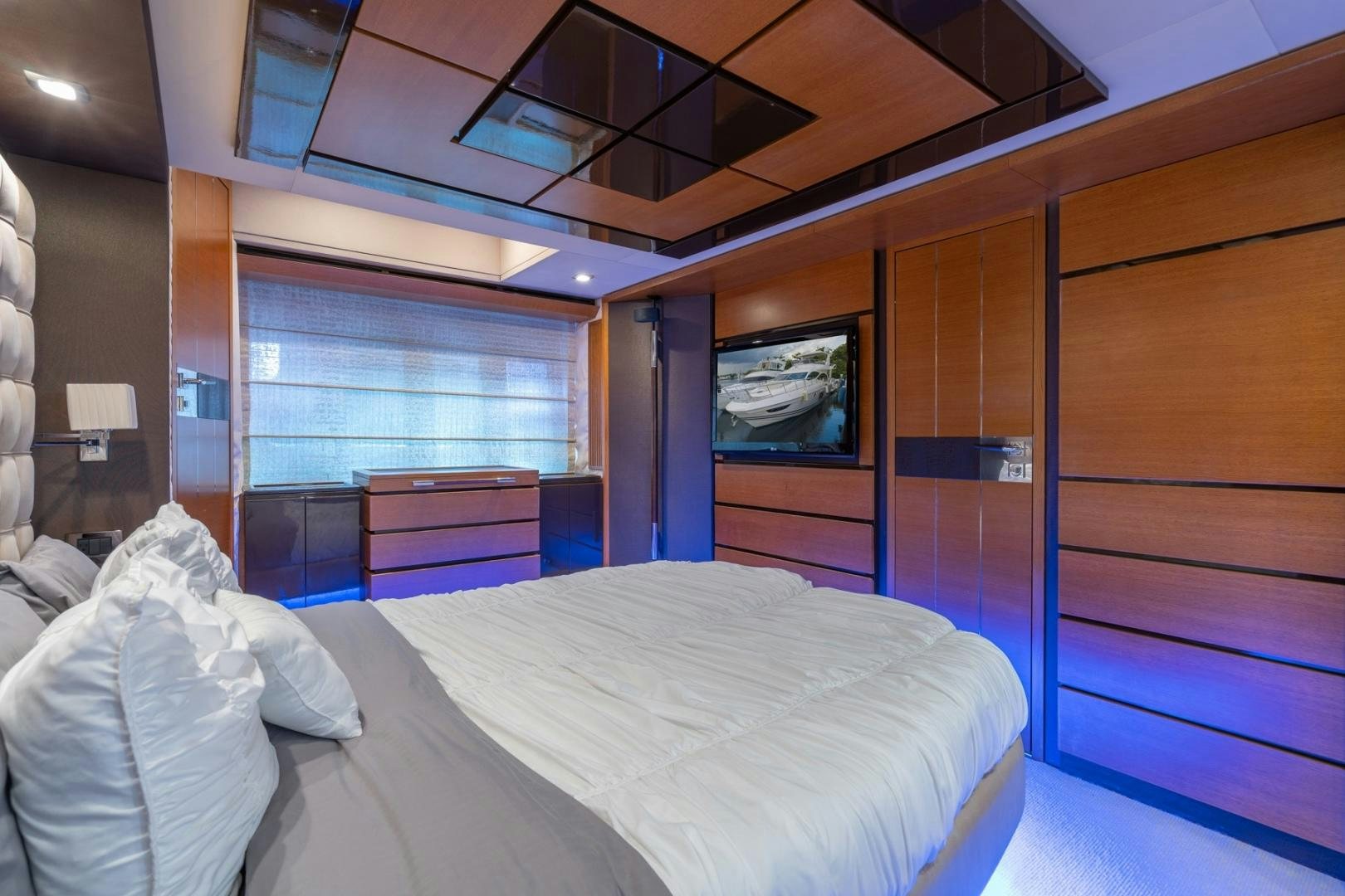 a room with a bed and a television aboard SYLVIA VI Yacht for Sale