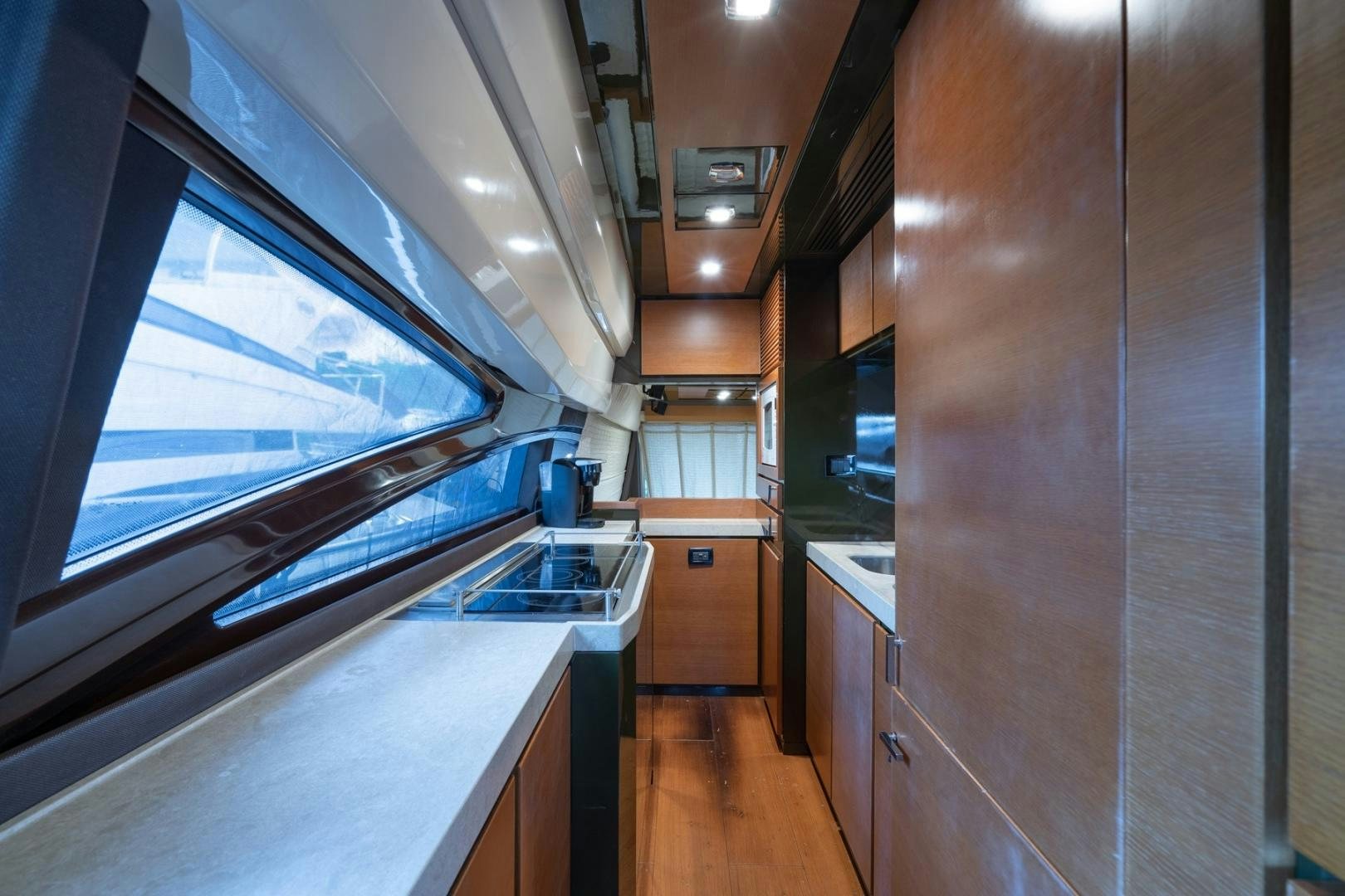 a kitchen with a large window aboard SYLVIA VI Yacht for Sale