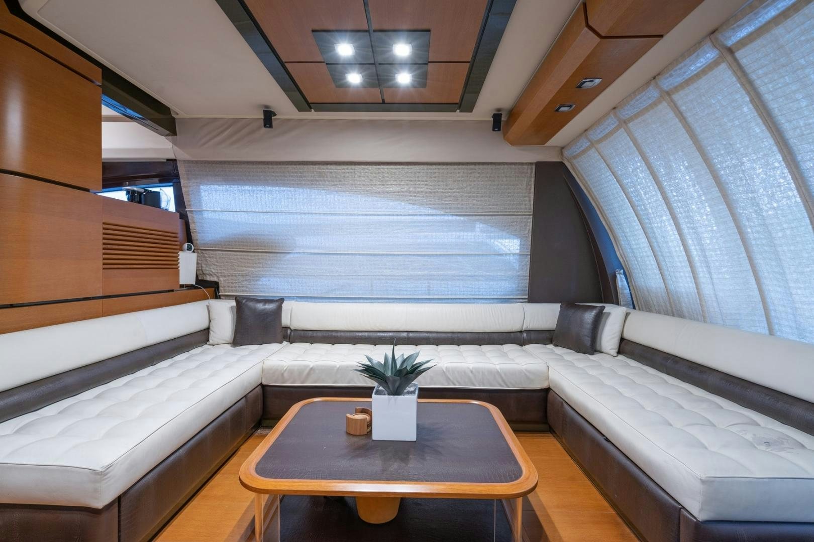 a room with a couch and a coffee table aboard SYLVIA VI Yacht for Sale