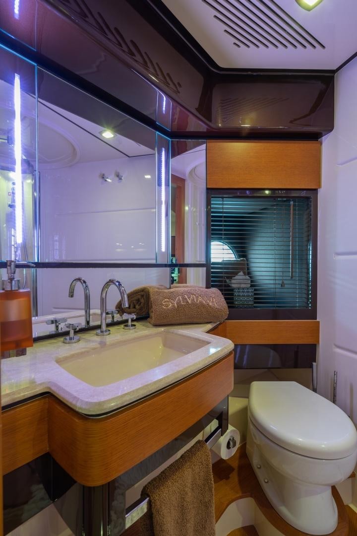 a bathroom with a sink and a toilet aboard SYLVIA VI Yacht for Sale