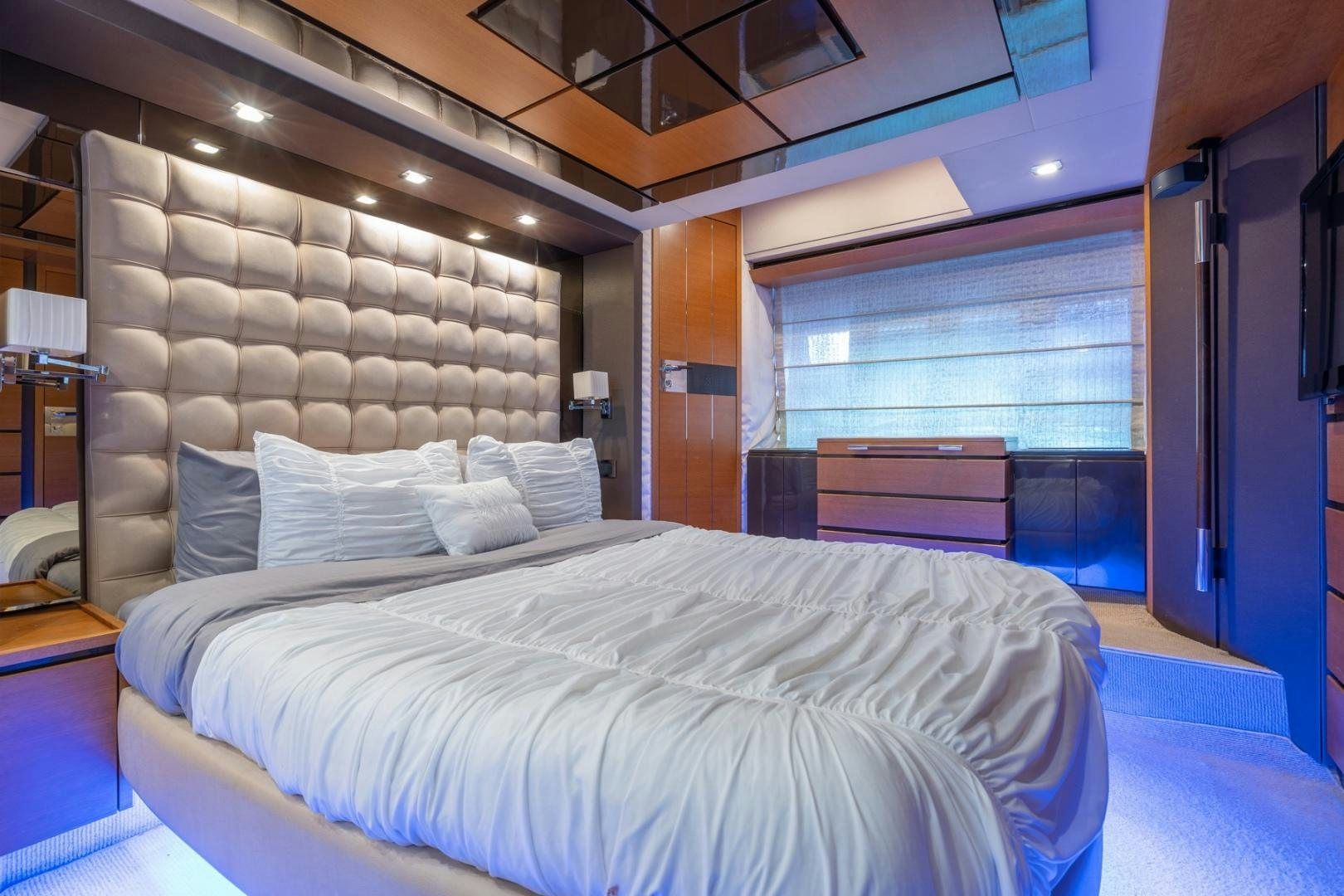 a bed with a white bed spread aboard SYLVIA VI Yacht for Sale