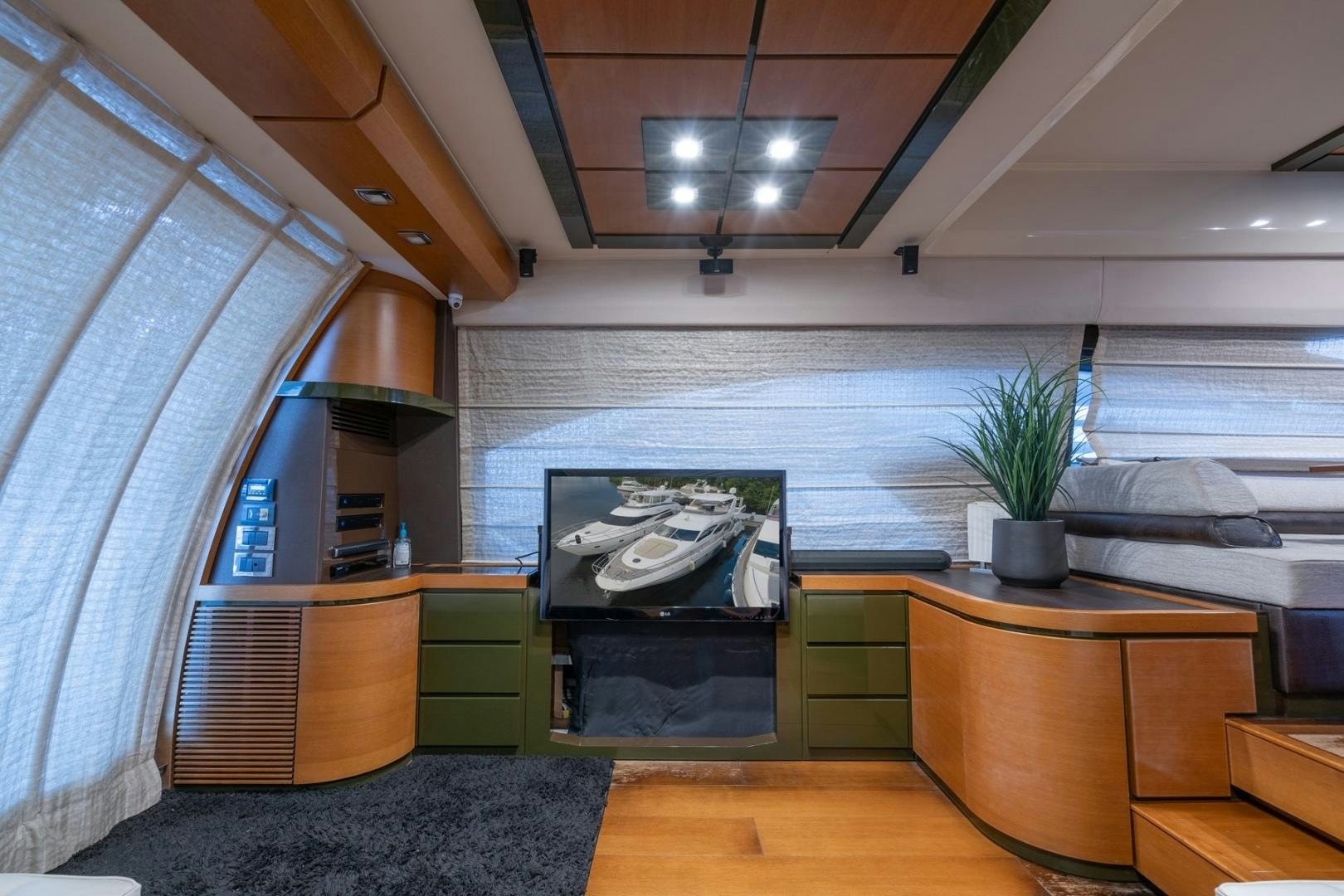 a room with a fireplace and a plant in it aboard SYLVIA VI Yacht for Sale