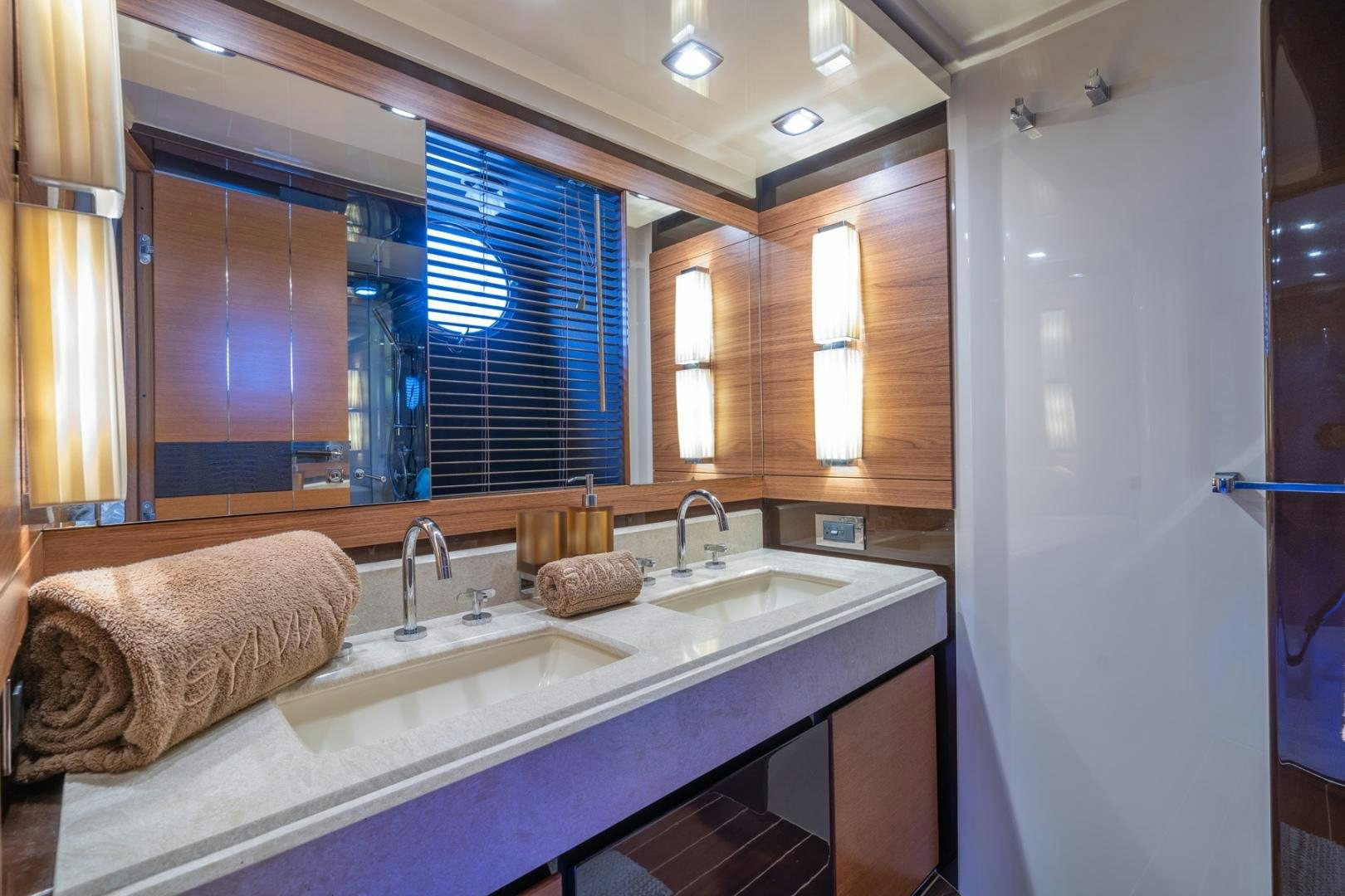 a bathroom with a countertop sink and a towel on the wall aboard SYLVIA VI Yacht for Sale