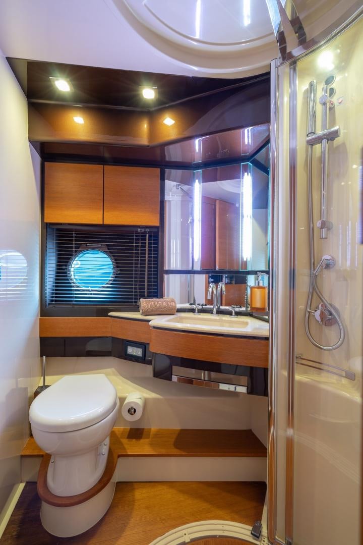 a bathroom with a toilet and a sink aboard SYLVIA VI Yacht for Sale