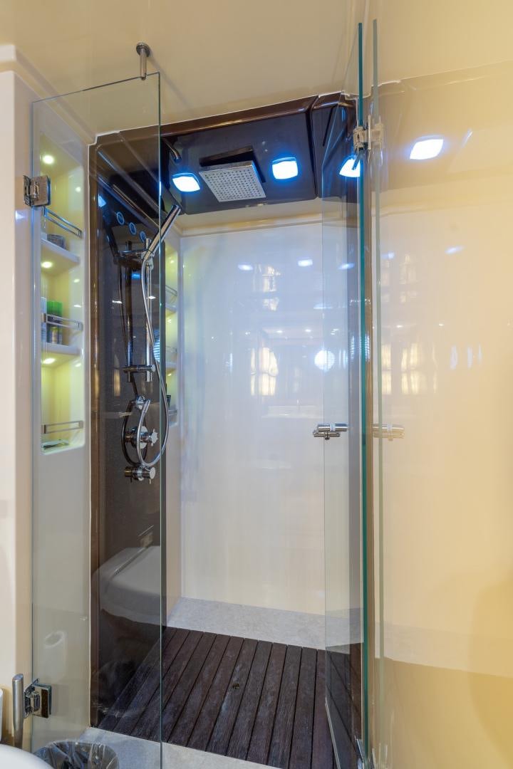 a bathroom with a glass shower aboard SYLVIA VI Yacht for Sale