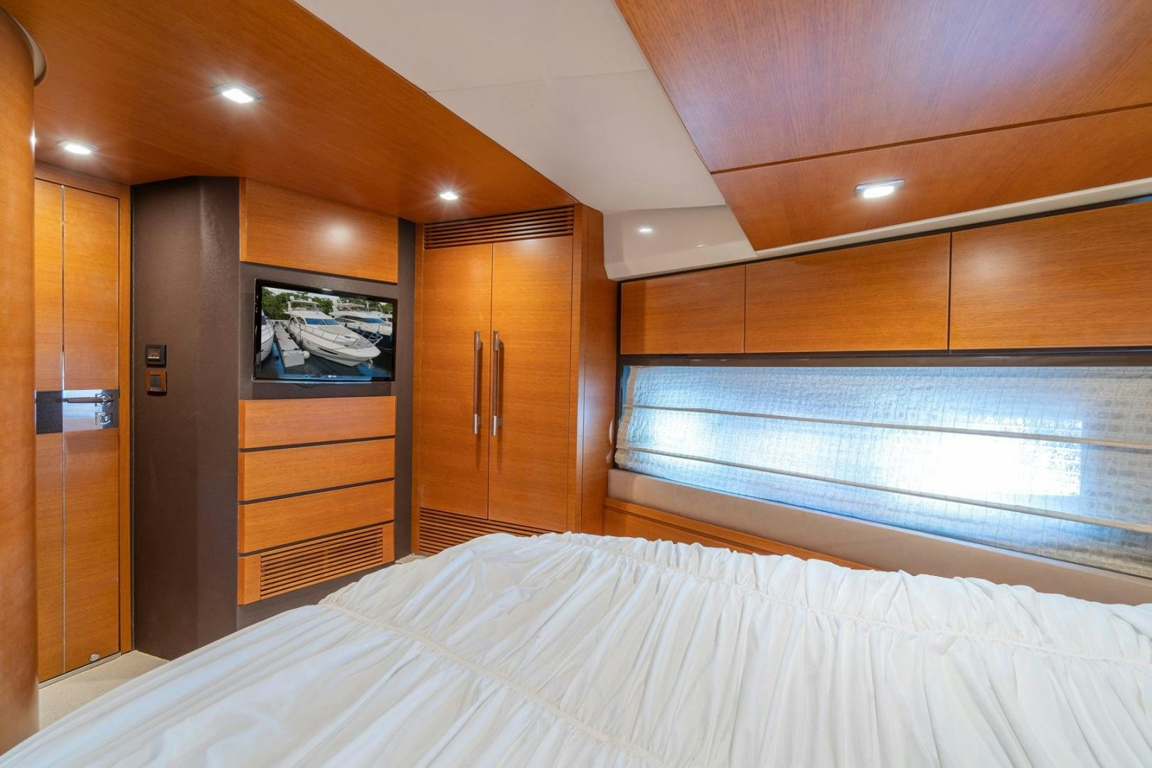a bedroom with a bed and a closet aboard SYLVIA VI Yacht for Sale