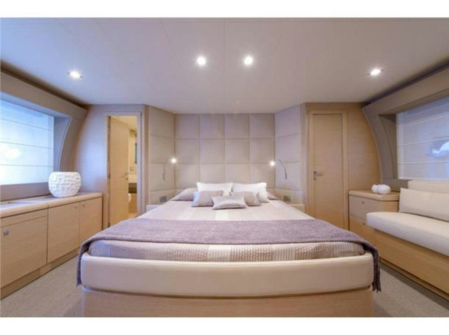 a bedroom with a bed and a dresser aboard BLUE ABALONE Yacht for Sale