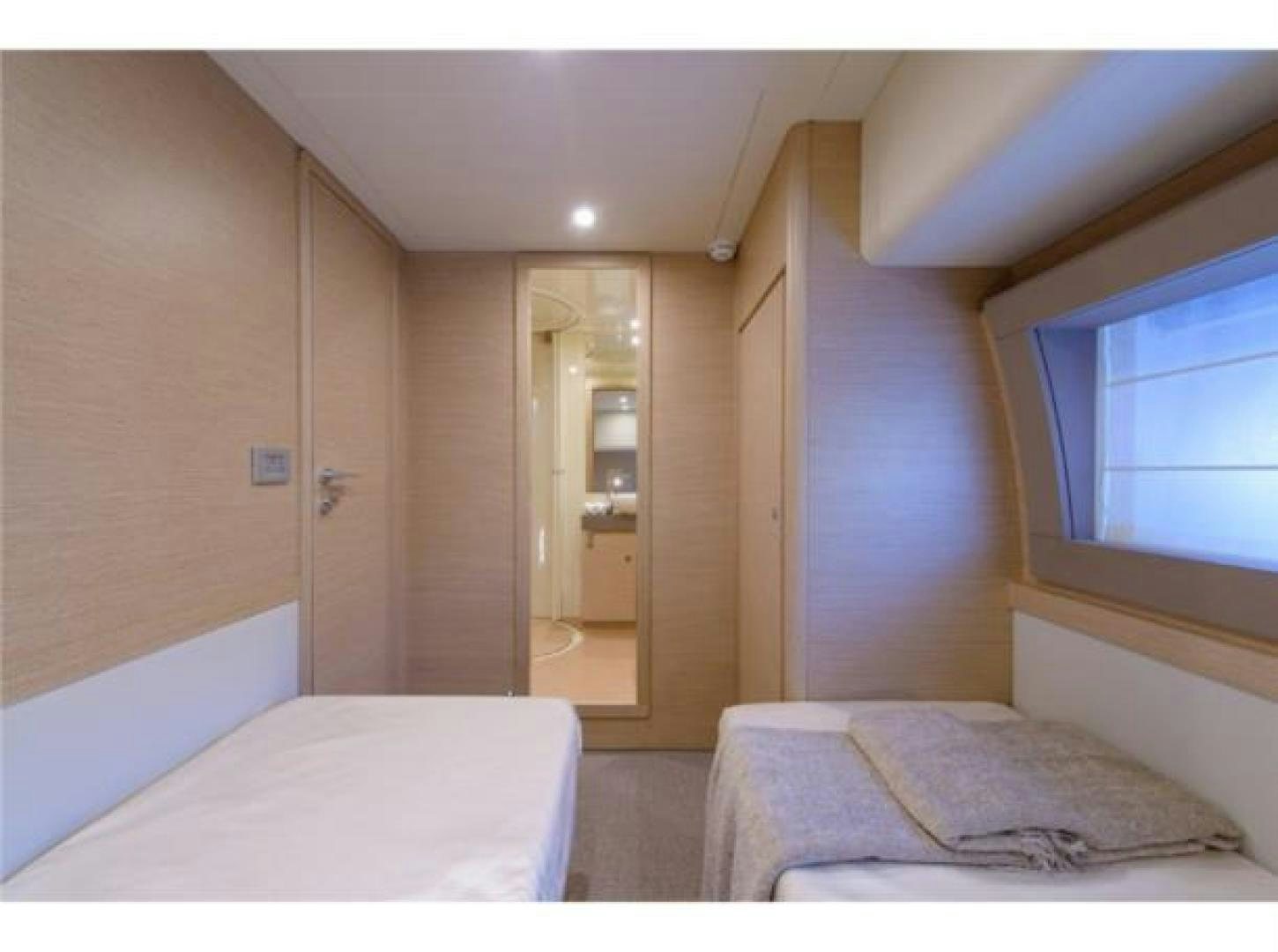 a bedroom with a bed and a mirror aboard BLUE ABALONE Yacht for Sale