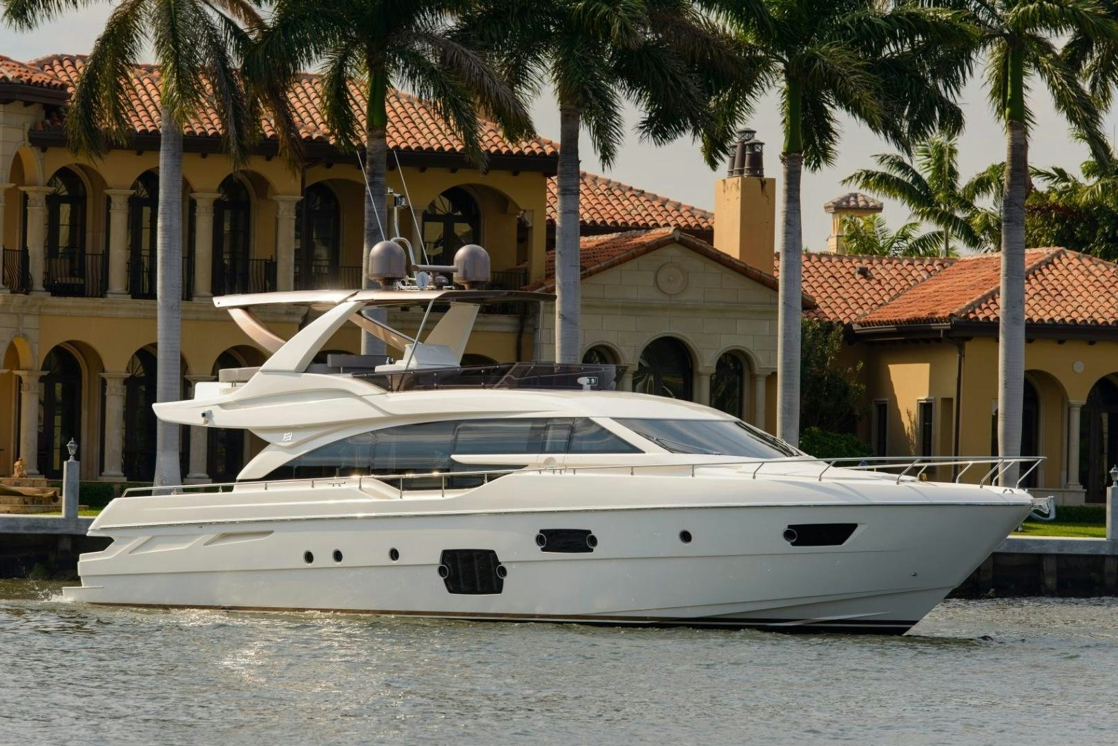 a white yacht in front of a building aboard BLUE ABALONE Yacht for Sale