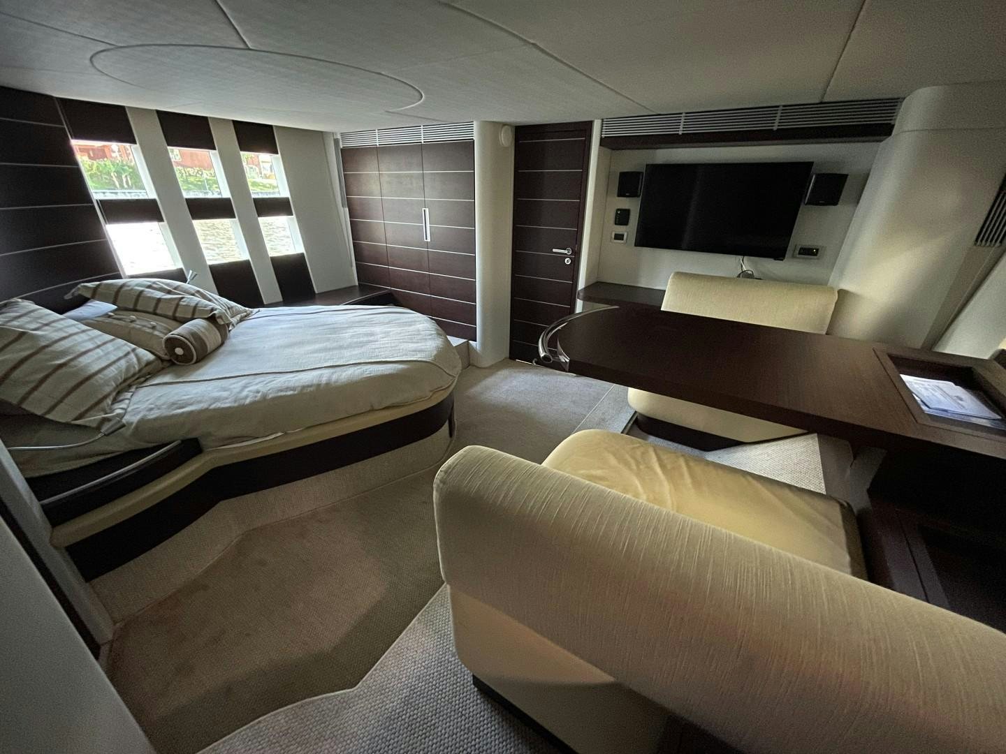 a room with a bed and a desk aboard DV8 Yacht for Sale