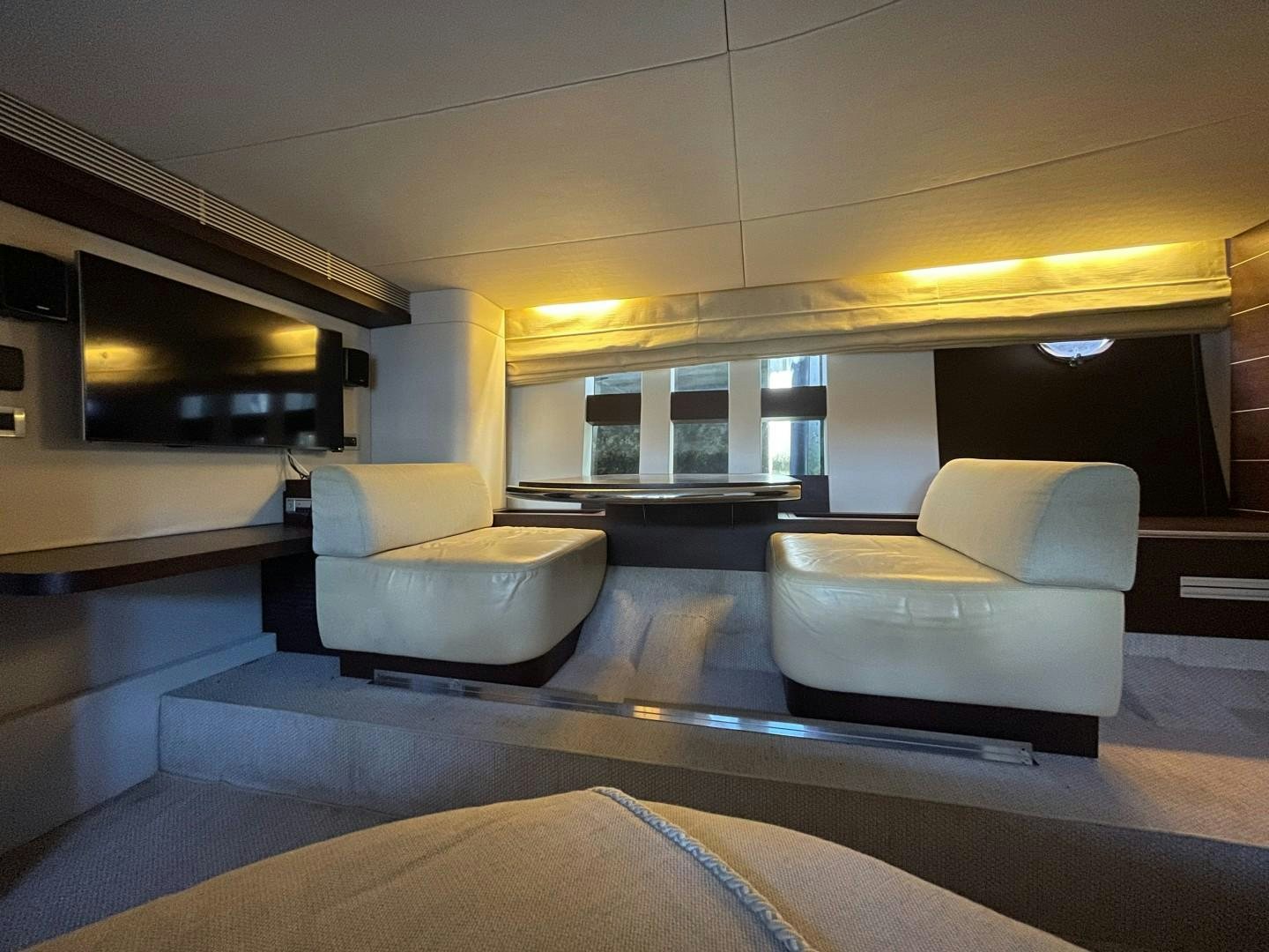 a living room with a couch and a fireplace aboard DV8 Yacht for Sale