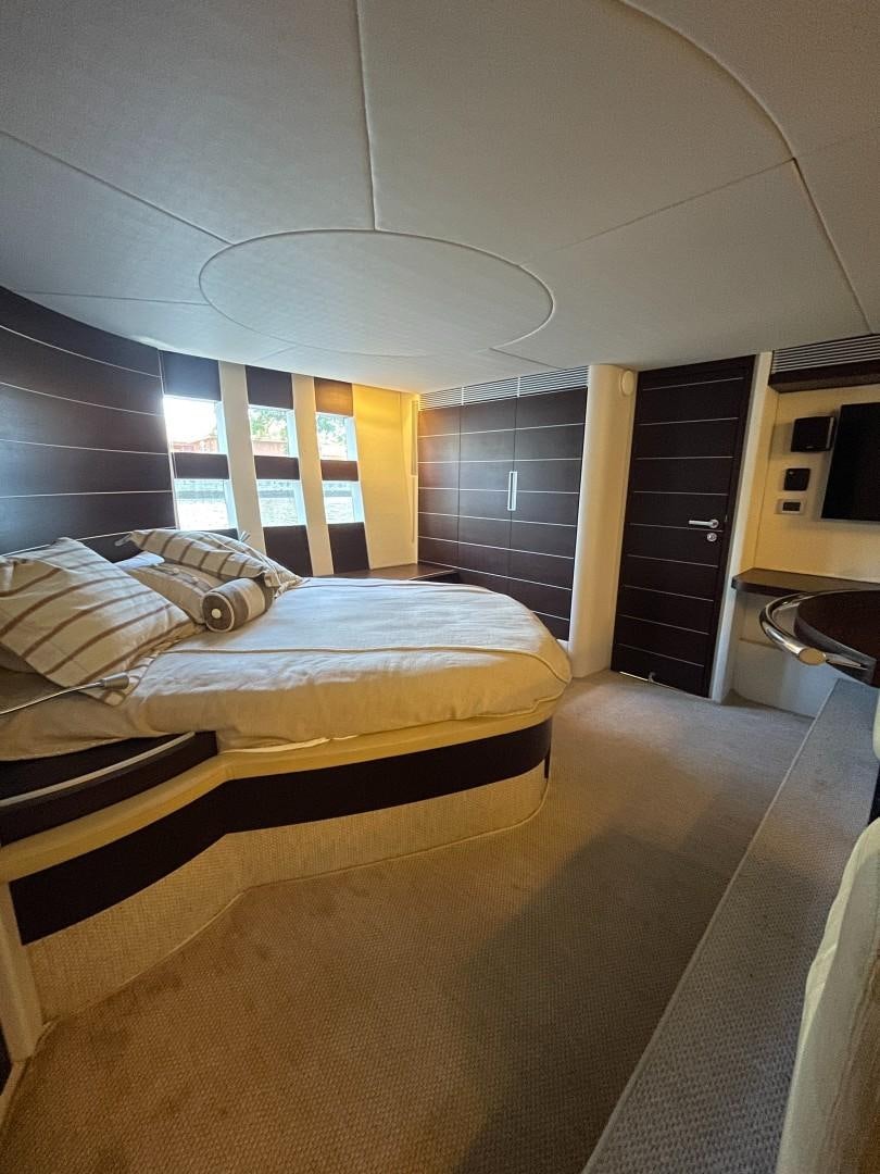 a bedroom with a bed aboard DV8 Yacht for Sale