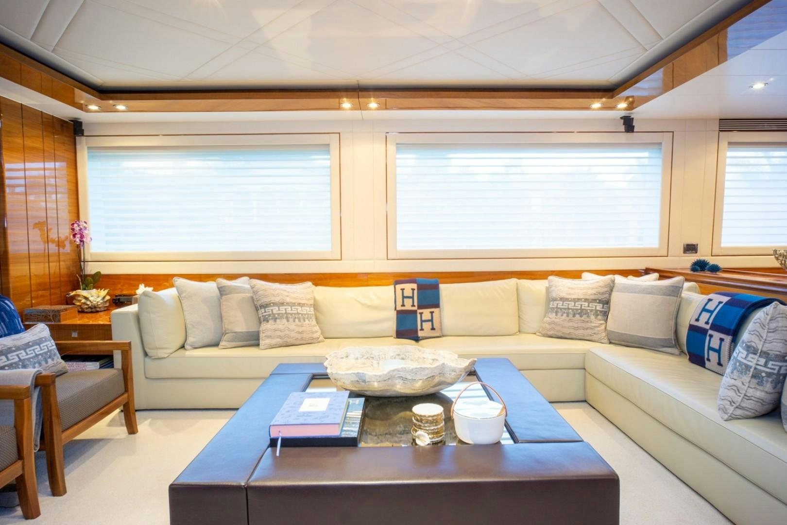 a living room with a couch and a table aboard IN THE ZONE Yacht for Sale