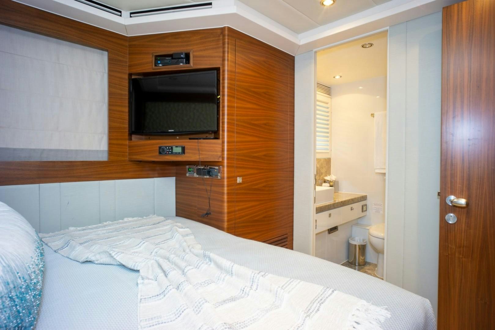 a bedroom with a bed and a television aboard IN THE ZONE Yacht for Sale