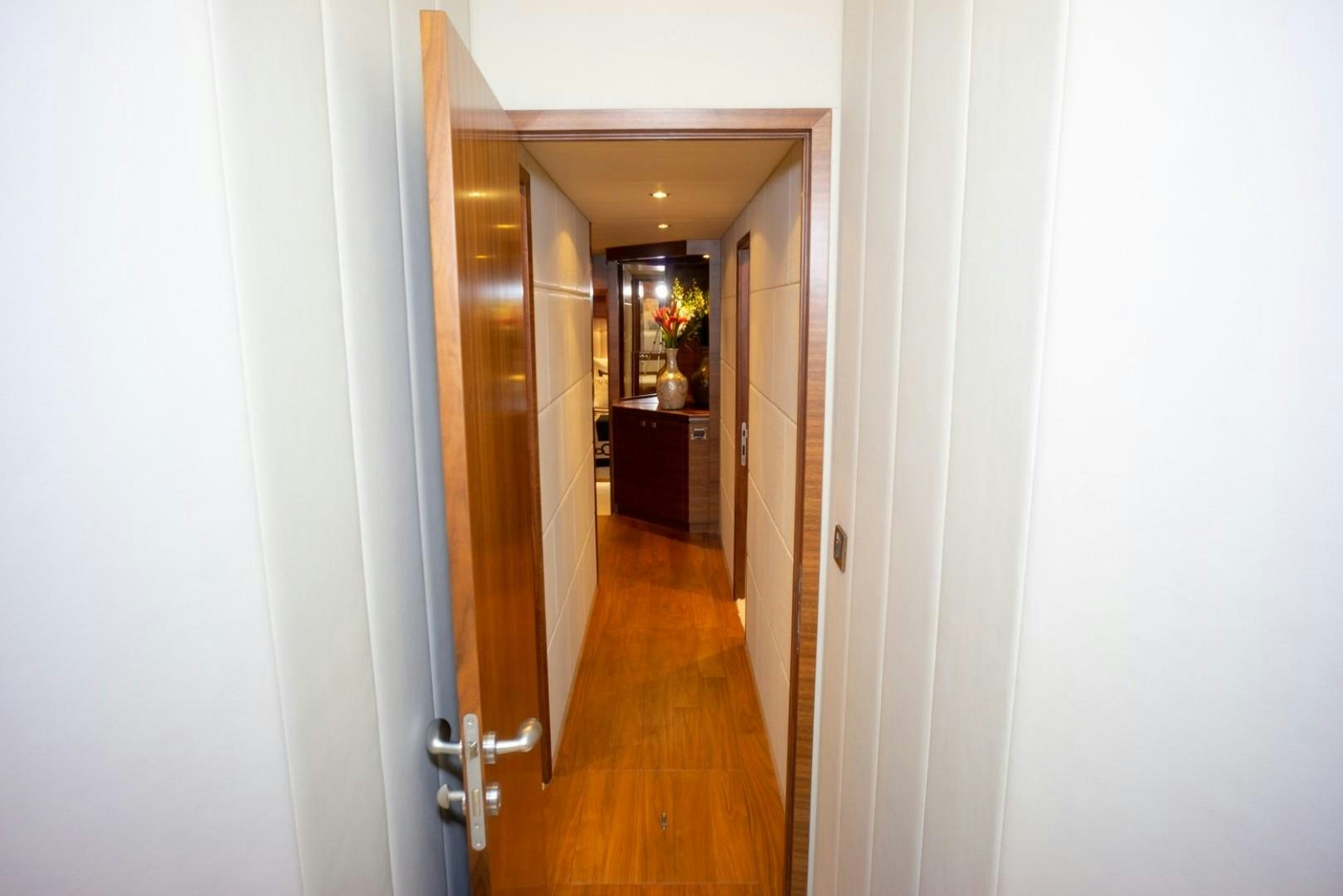 a hallway with a door and a wood door aboard IN THE ZONE Yacht for Sale