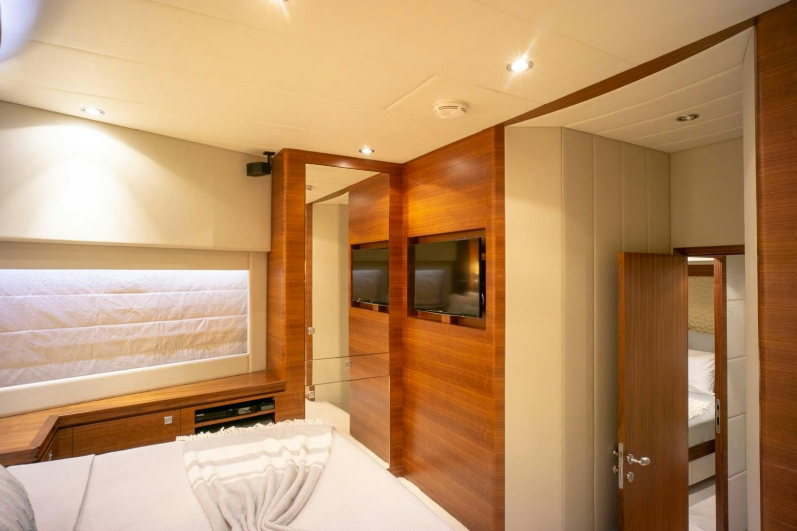 a room with a bed and a closet aboard IN THE ZONE Yacht for Sale