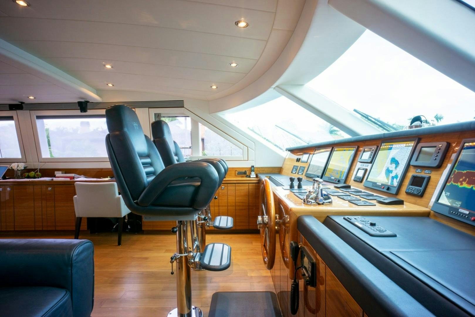 inside of a vehicle with a desk and chairs and computers aboard IN THE ZONE Yacht for Sale