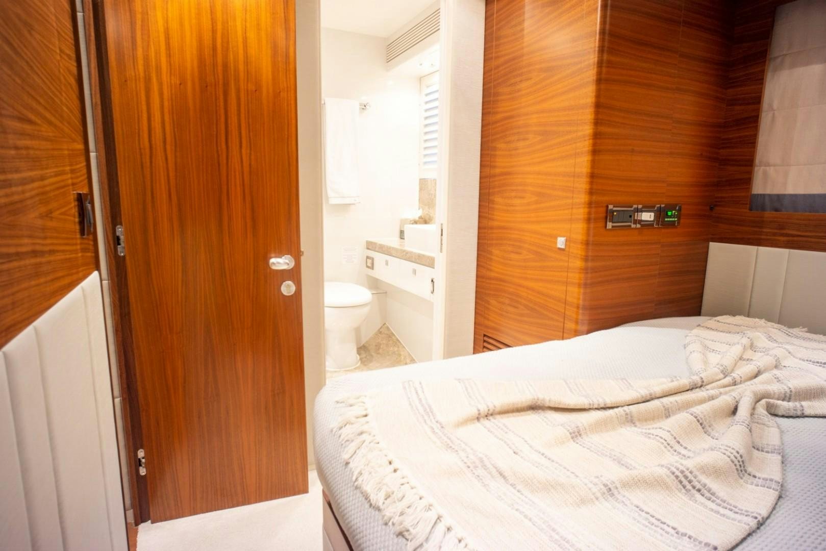 a room with a bed and a closet aboard IN THE ZONE Yacht for Sale