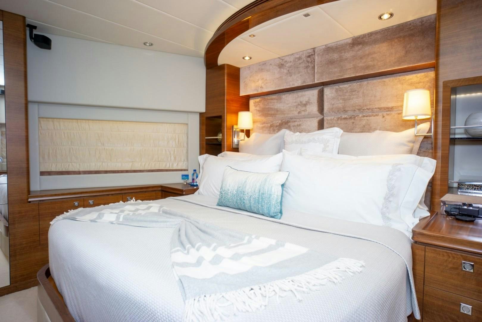 a large bed with white sheets aboard IN THE ZONE Yacht for Sale