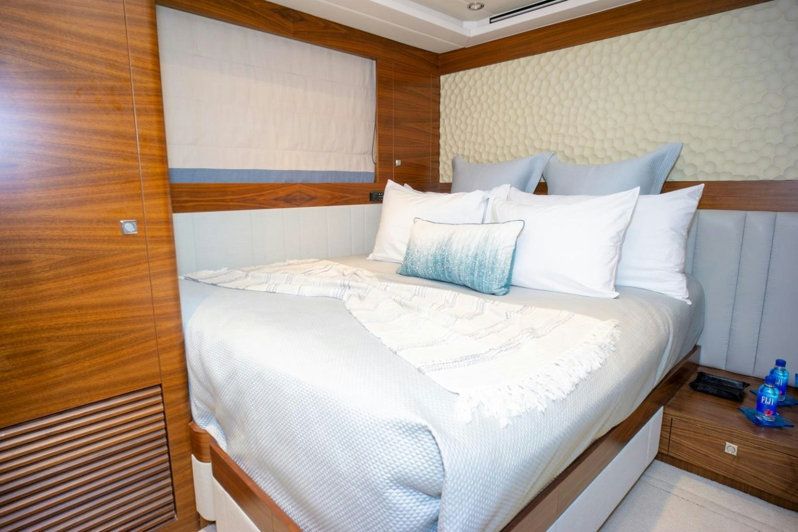 a bed with white sheets aboard IN THE ZONE Yacht for Sale