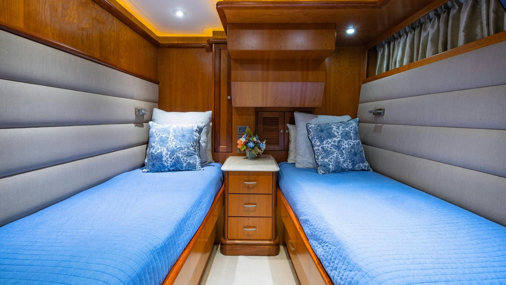 a room with a bed and a dresser aboard MAGICAL DAYS Yacht for Sale