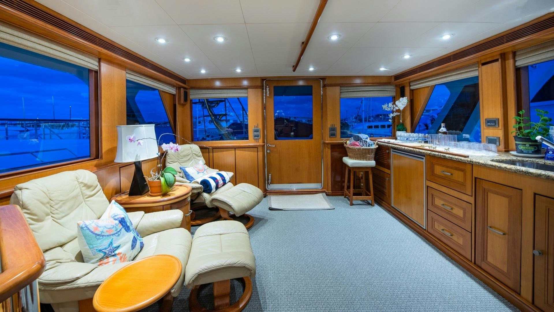a person lying on a bed in a living room aboard MAGICAL DAYS Yacht for Sale