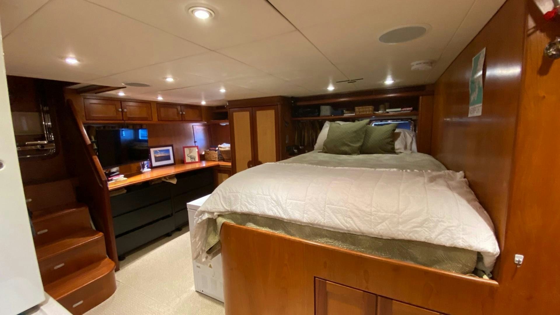 a room with a bed and desk aboard MAGICAL DAYS Yacht for Sale