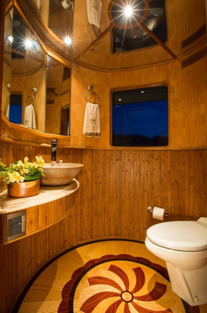 a bathroom with a sink toilet and a mirror aboard MAGICAL DAYS Yacht for Sale